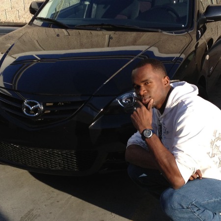 Darius Benson posing with his luxurious car brand Mazda